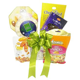 Gift hamper with assorted snacks and green ribbon, ideal for flower delivery gifts