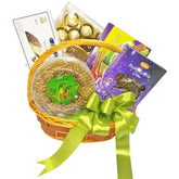 Gift hamper with assorted snacks and dates, decorated with a green ribbon for flower delivery