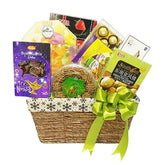 Gift basket with flowers, dates, cookies and chocolates for flower delivery in Singapore