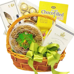 Gift basket with choco filled dates, assorted snacks, and a green ribbon for flower delivery