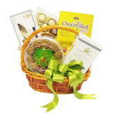 Gift basket with green ribbon, assorted treats and chocolates, ideal for flower delivery gifts