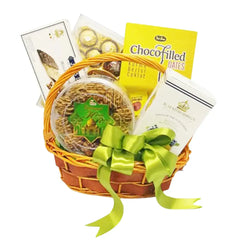 Gift basket with green ribbon, assorted treats and chocolates, ideal for flower delivery gifts