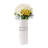 Elegant condolence flower stand with white daisies, yellow roses for Singapore delivery