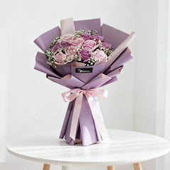 Elegant purple and pink rose bouquet with baby’s breath, ideal for flower delivery in Singapore