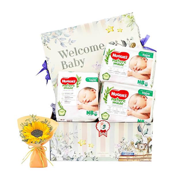 Flower delivery of a welcome baby gift box with diapers and a sunflower bouquet