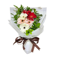 Hand-tied bouquet with red, white, and pink gerbera daisies, ideal for flower delivery.