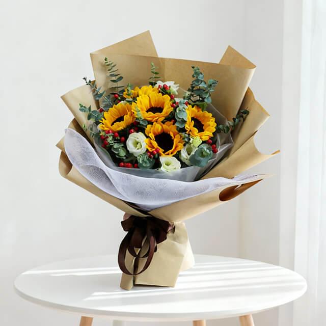 Sunflower bouquet with greenery and white blooms for online flower delivery in Singapore