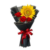 Sunflower and red rose bouquet wrapped in black paper with red ribbon for flower delivery
