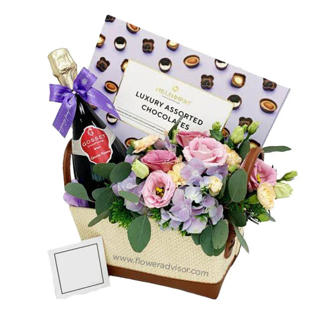 Gift basket with fresh flower bouquet, wine, and chocolates for flower delivery