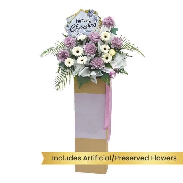 Purple and white flower arrangement with 'Forever Cherished' sign for flower delivery