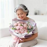Elderly woman happily receives pink rose bouquet, symbolizing flower delivery service