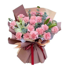 Pink carnation bouquet with lilies and greenery, wrapped for flower delivery in Singapore