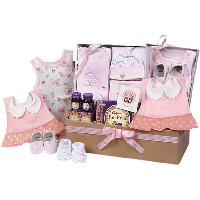 Baby gift hamper with pink baby clothes, shoes, snacks, ideal for gifting with flower delivery
