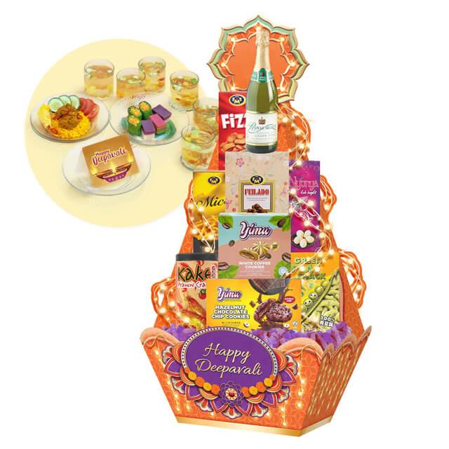 Deepavali festive hamper with assorted snacks, sweets, drinks and a Happy Deepavali sign. Flower delivery.