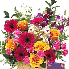 Vibrant flower arrangement with pink gerberas, yellow roses, and orchids for flower delivery