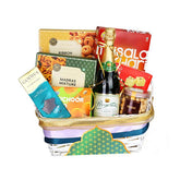 Gift basket with snacks, chocolate, grape juice and treats, ideal for hamper flower delivery Singapore.