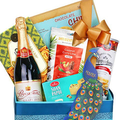 Gourmet gift hamper with sparkling juice, snacks, sweets and festive bow, ideal for delivery