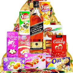 Gift hamper with bottle of whisky, assorted snacks and cookies for flower delivery