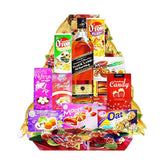 Gift hamper of snacks and whisky arranged with decorative flowers for delivery