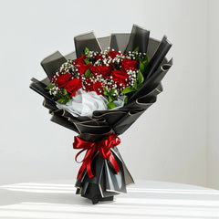 Red rose bouquet with baby's breath in black wrapping, elegant flower delivery arrangement
