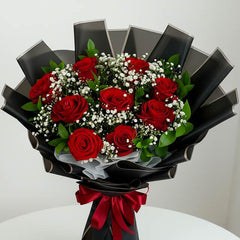 Red rose bouquet with baby's breath in black wrapping, ideal for flower delivery