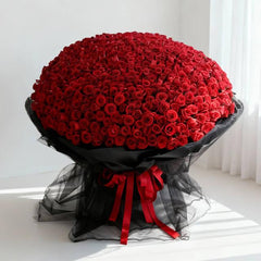 Large bouquet of red roses with black wrapping, ideal for flower delivery in Singapore