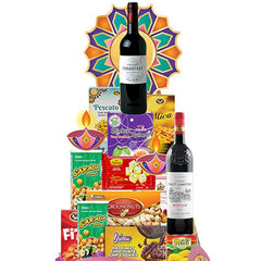 Diwali gift hamper with wine, assorted snacks and festive decorations for flower delivery