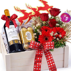 Festive flower delivery gift set with red roses, wine, Ferrero Rocher, and red ribbon in a box