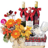 Festive flower delivery basket with orange flowers, three wine bottles, glasses, and holiday decor