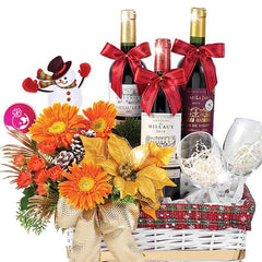 Festive flower delivery basket with orange flowers, three wine bottles, glasses, and holiday decor