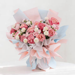 Pink rose and white pompom bouquet with pastel wrapping for flower delivery