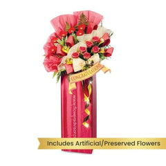 Grand opening flower stand in red and cream with congratulatory ribbon, available for delivery