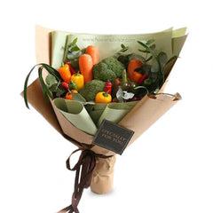 Fresh vegetable bouquet with broccoli, carrots, peppers and greens for delivery
