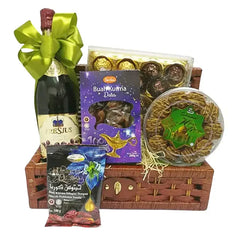 Festive gift basket with dates, chocolates, snacks and a bottle, perfect for flower delivery gifts