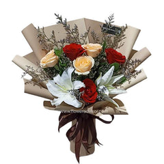 Hand bouquet with peach and red roses, white lilies, perfect for flower delivery in Singapore