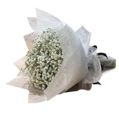 Hand bouquet of fresh white baby's breath flowers wrapped for delivery