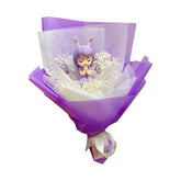 Purple flower bouquet with preserved baby’s breath and a cute praying angel doll for delivery