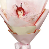Pink bouquet with preserved flowers and an angel doll for flower delivery