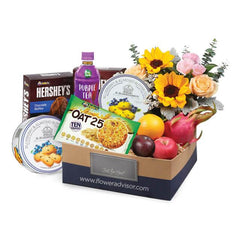 Flower delivery gift box with sunflowers, roses, fresh fruits, cookies, snacks, and tea