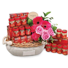 Flower delivery basket with pink roses, gerberas, and health tonic jars in Singapore