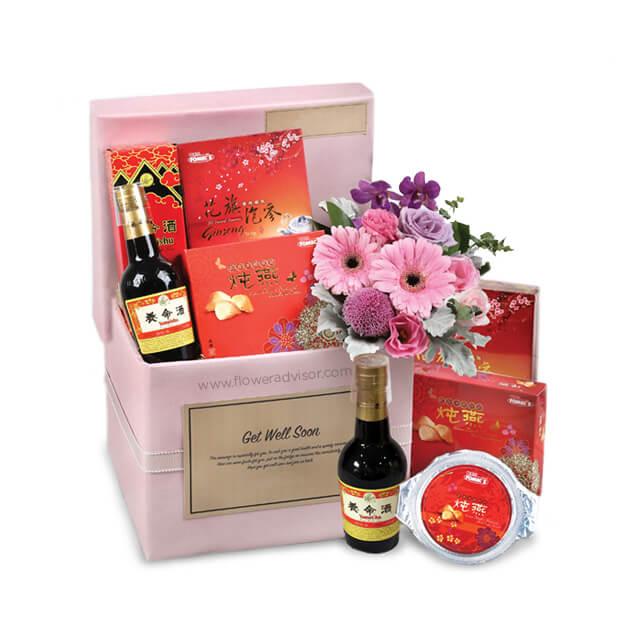 Get well soon hamper with fresh pink flowers and gift items for flower delivery