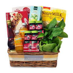 Flower delivery hamper with green plant, healthy snacks, drinks, and gift basket arrangement