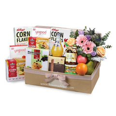 Flower delivery hamper with fresh flowers, breakfast cereals, snacks, fruit, and honey.