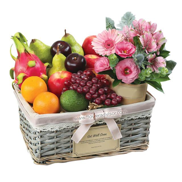 Fresh fruit hamper with mixed flowers in a basket, ideal for flower delivery gifts