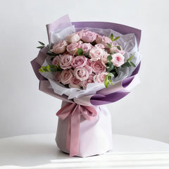 Elegant pink rose bouquet with lush greenery, wrapped for flower delivery gift