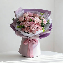 Elegant bouquet of pink roses wrapped in pastel paper for flower delivery in Singapore