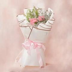 Pink carnation bouquet wrapped in white paper with a pink ribbon, perfect for flower delivery
