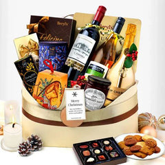 Flower delivery gift hamper with wine, festive treats, chocolates, and cookies