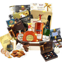 Luxury festive hamper with flowers, cookies, wine, chocolates and candles for gift delivery