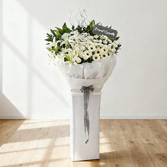 Elegant white sympathy flower stand with lilies, daisies and free delivery in Singapore